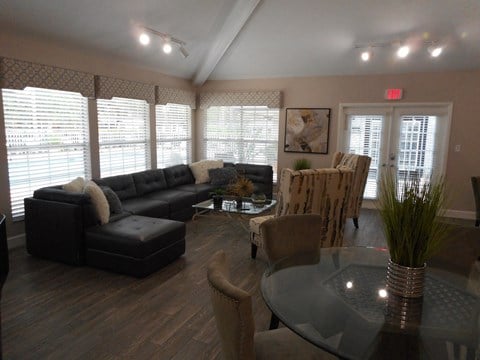 a living room with a couch and a table and chairs